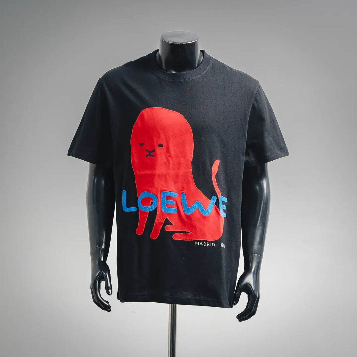 Black LOEWE T-shirt with red rabbit graphic, blue “LOEWE” text, and “MADRID”