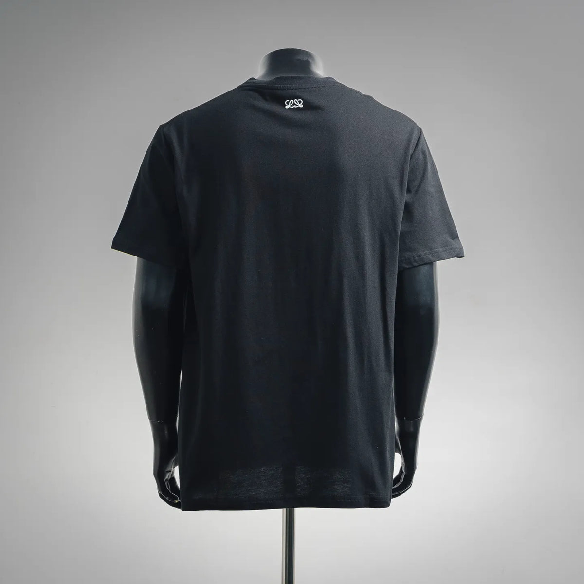Black LOEWE short-sleeve T-shirt on mannequin, back view with small neck logo