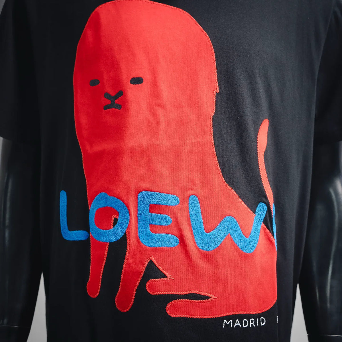 Black LOEWE T-shirt front graphic: red rabbit, blue “LOEWE” lettering, “MADRID”