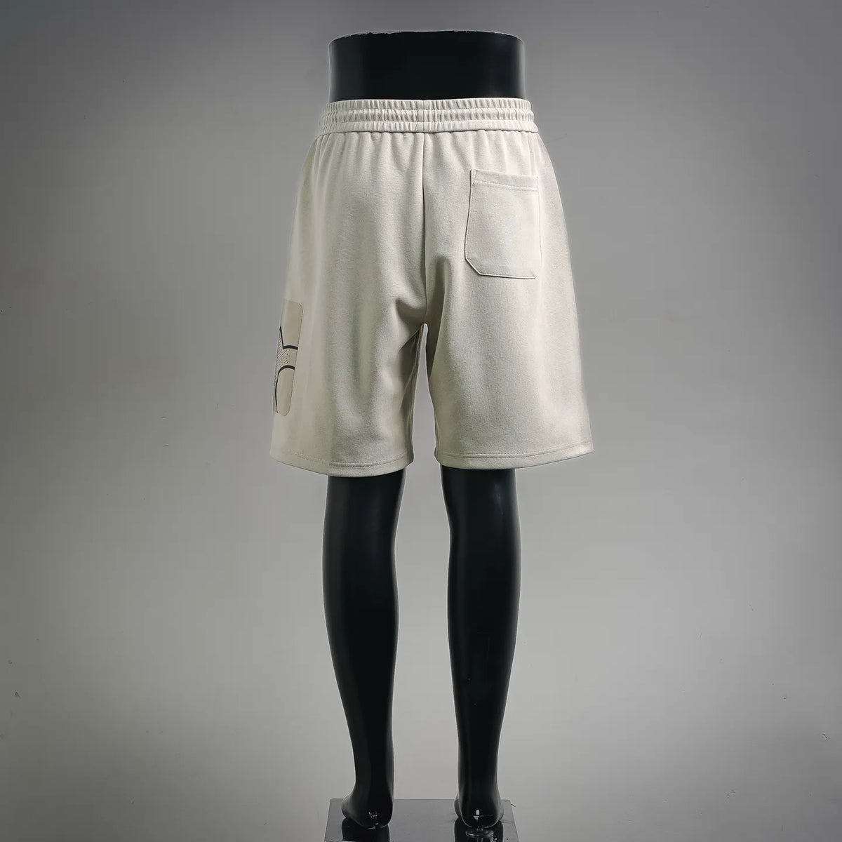 Light cream drawstring shorts with single front pocket and side logo patch