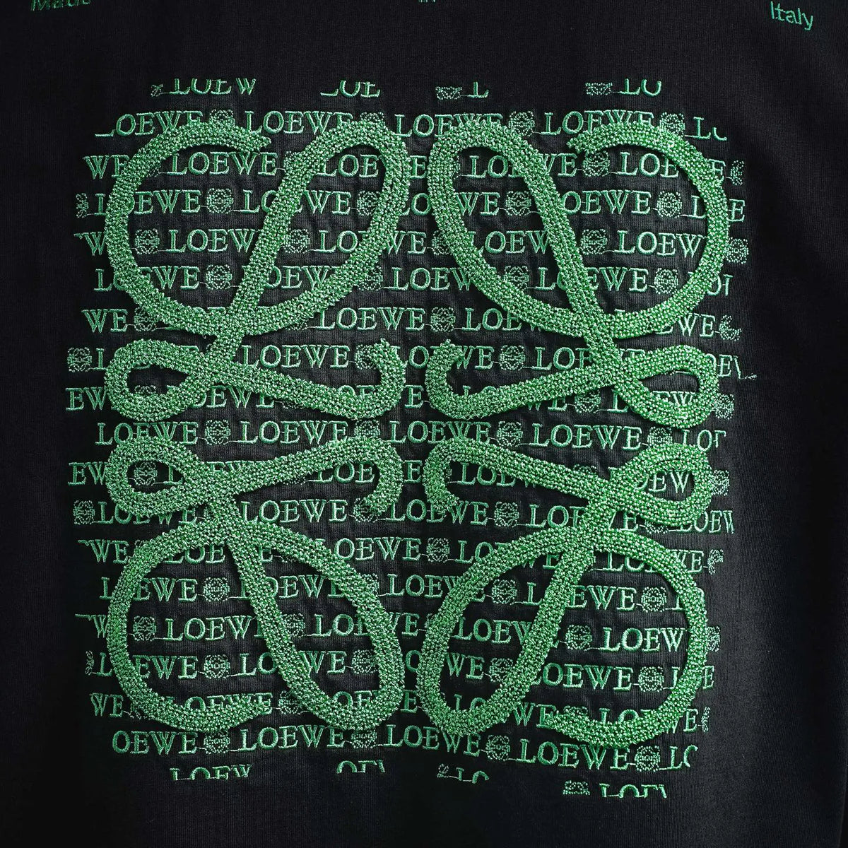 Navy T-shirt with dense green LOEWE pattern print, close-up
