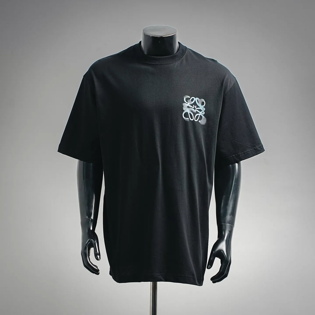 Black short-sleeve t-shirt with light-blue emblem on chest