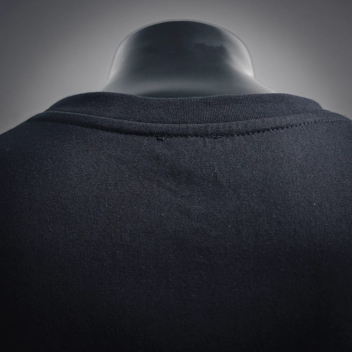 Black T-shirt collar and shoulder seam with ribbed crew neckline