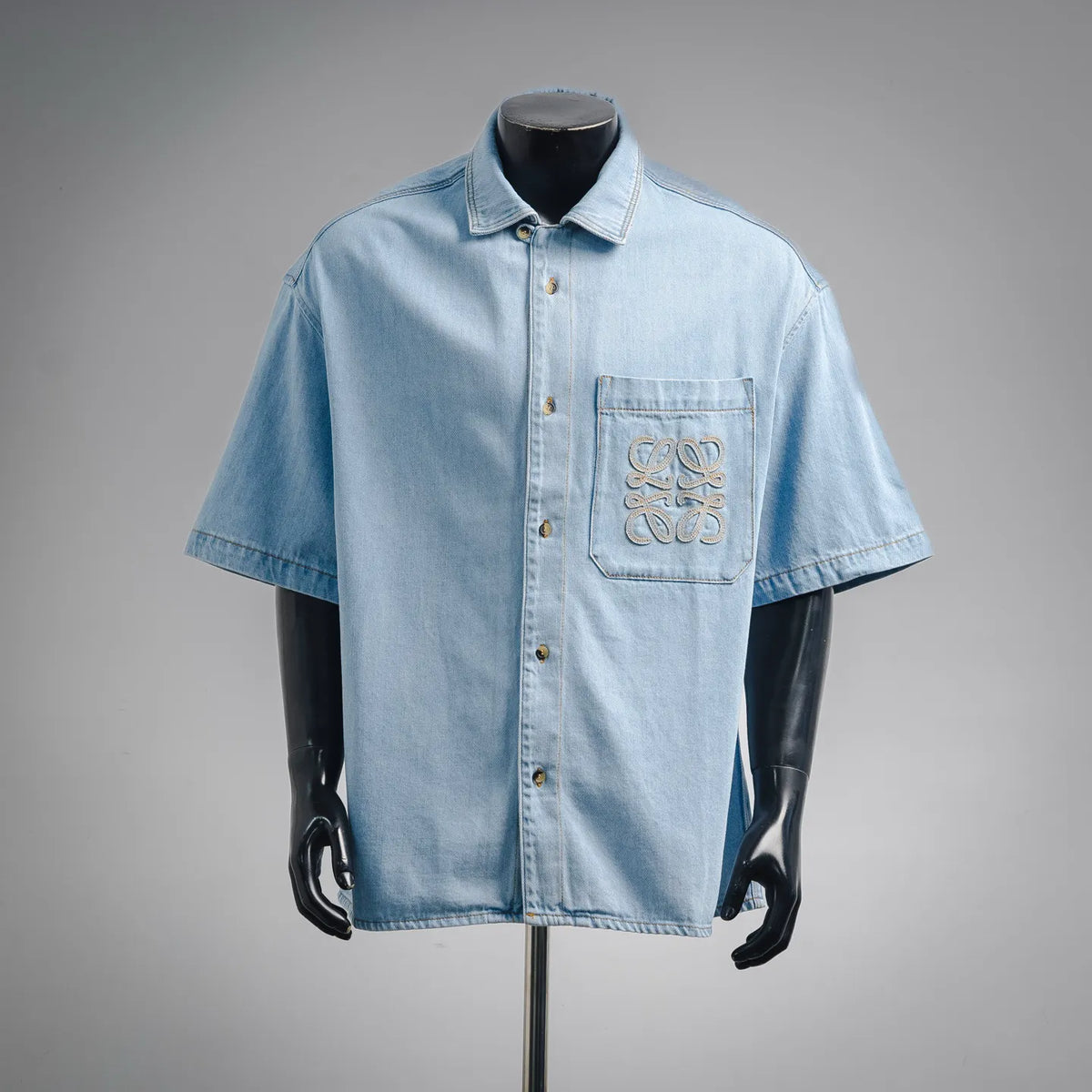 Light blue denim short-sleeve button shirt with embroidered chest logo pocket