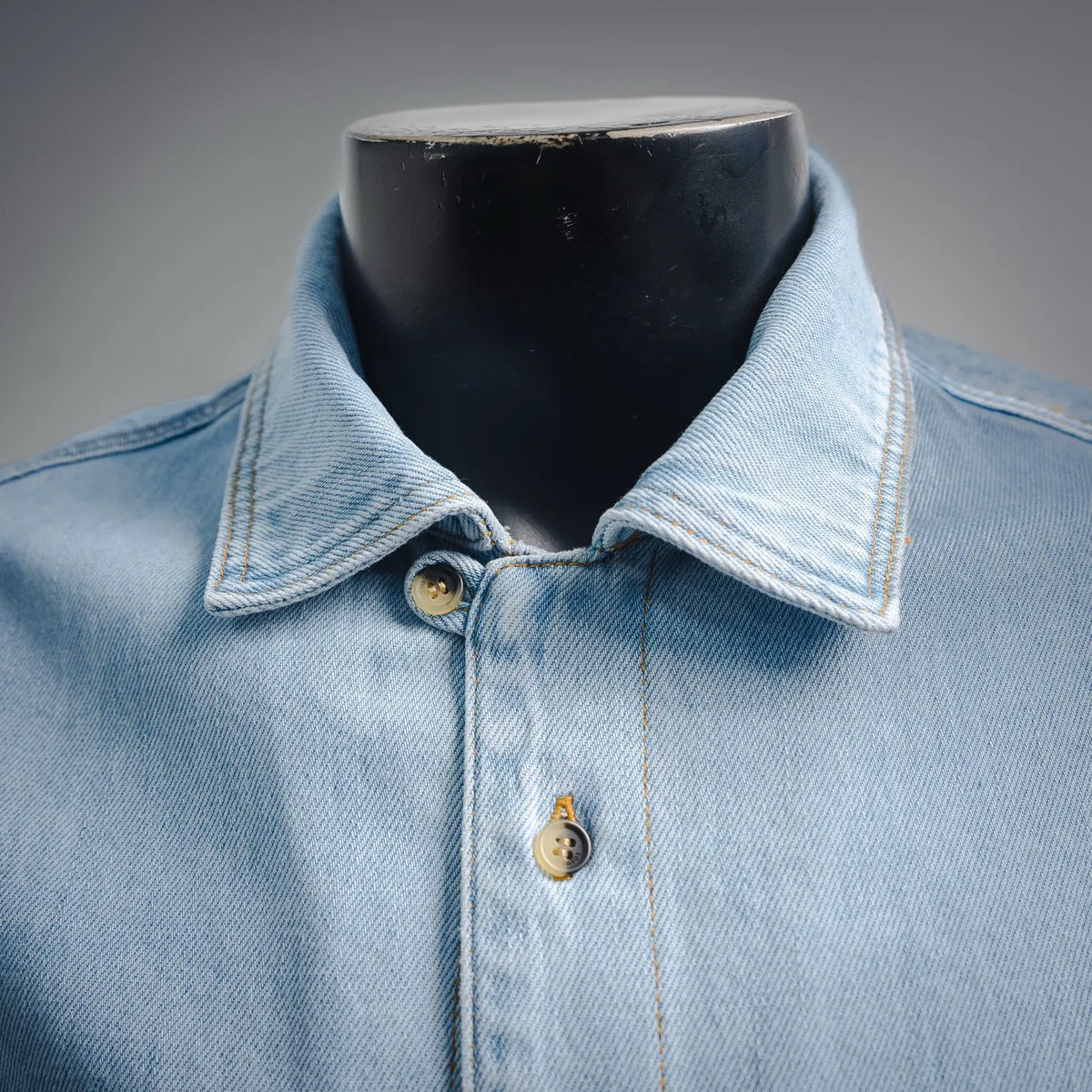 Light blue denim shirt with pointed collar and two-button placket
