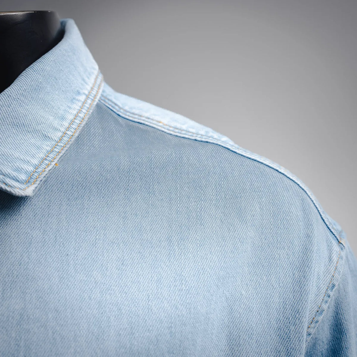 Light blue denim shoulder and collar with contrast stitching