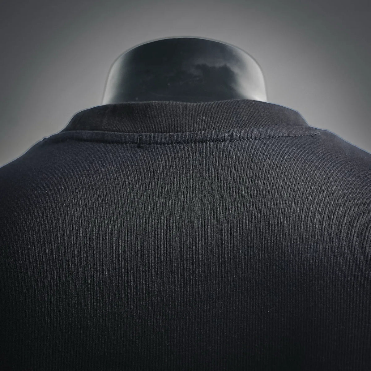 Black crewneck T-shirt collar close-up on mannequin