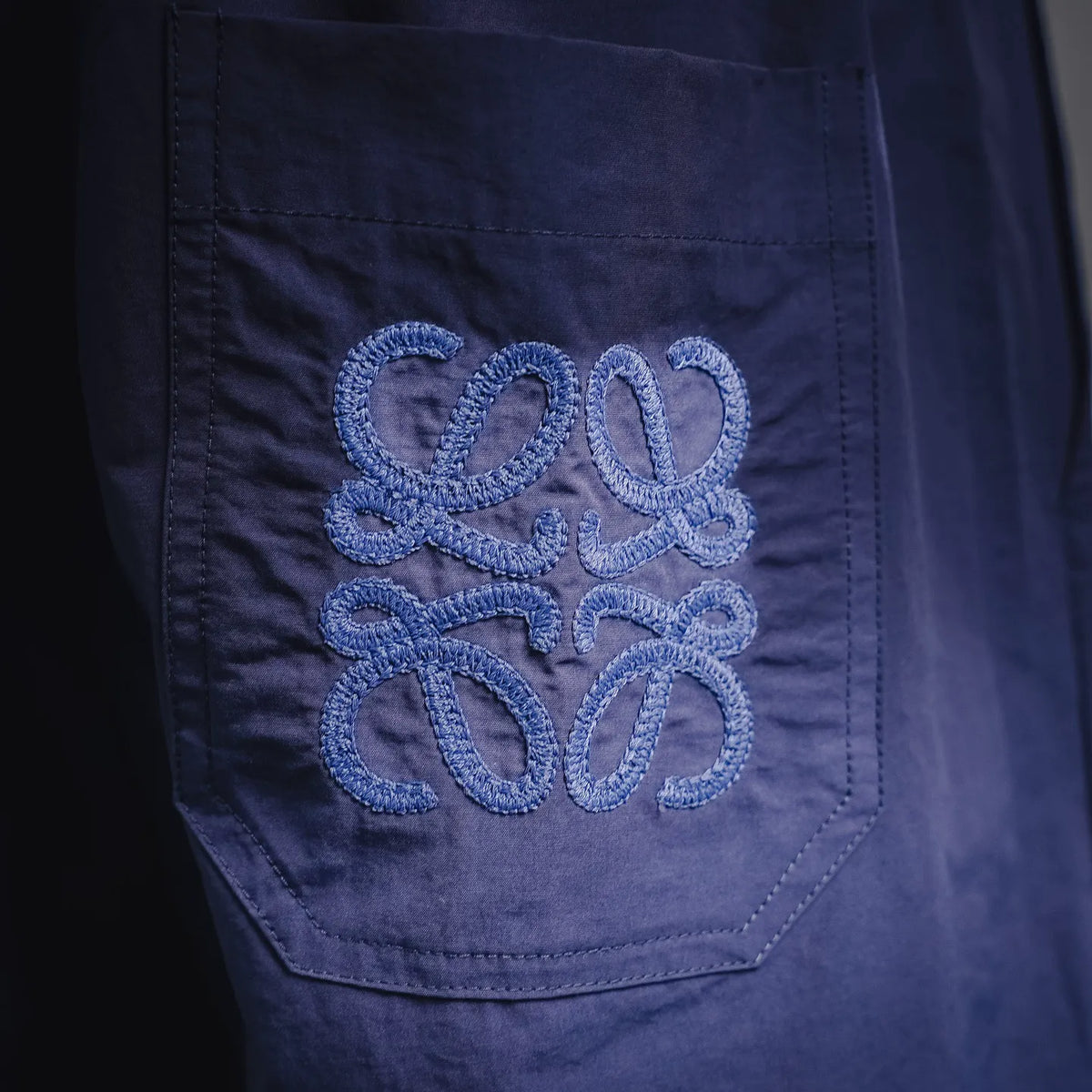 LOEWE navy pants with embroidered logo patch on side pocket