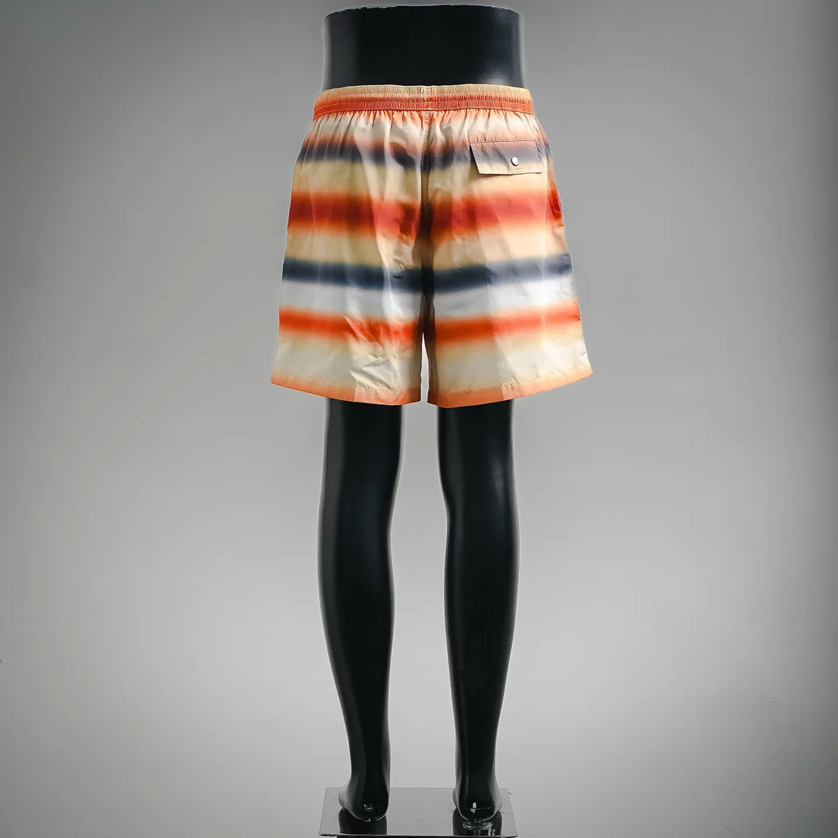 Back view of tie-dye swim shorts with elastic waistband and pull-on fit