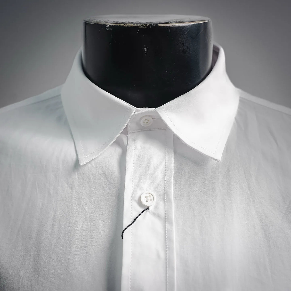 White LOEWE button-up shirt collar with buttoned front placket close-up