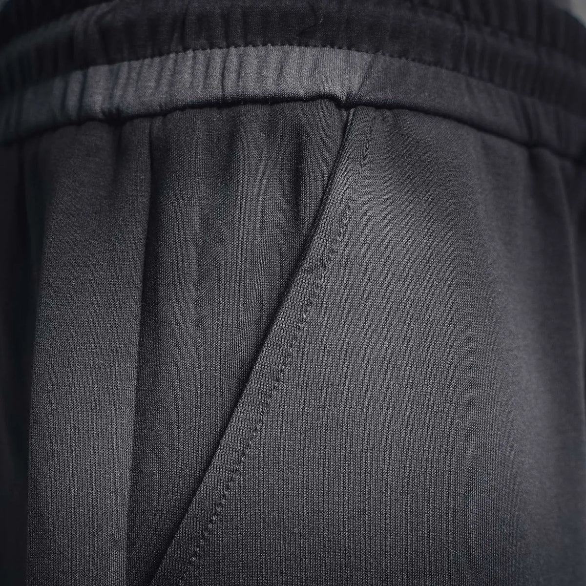 Black shorts interior seam and waistband stitching detail.