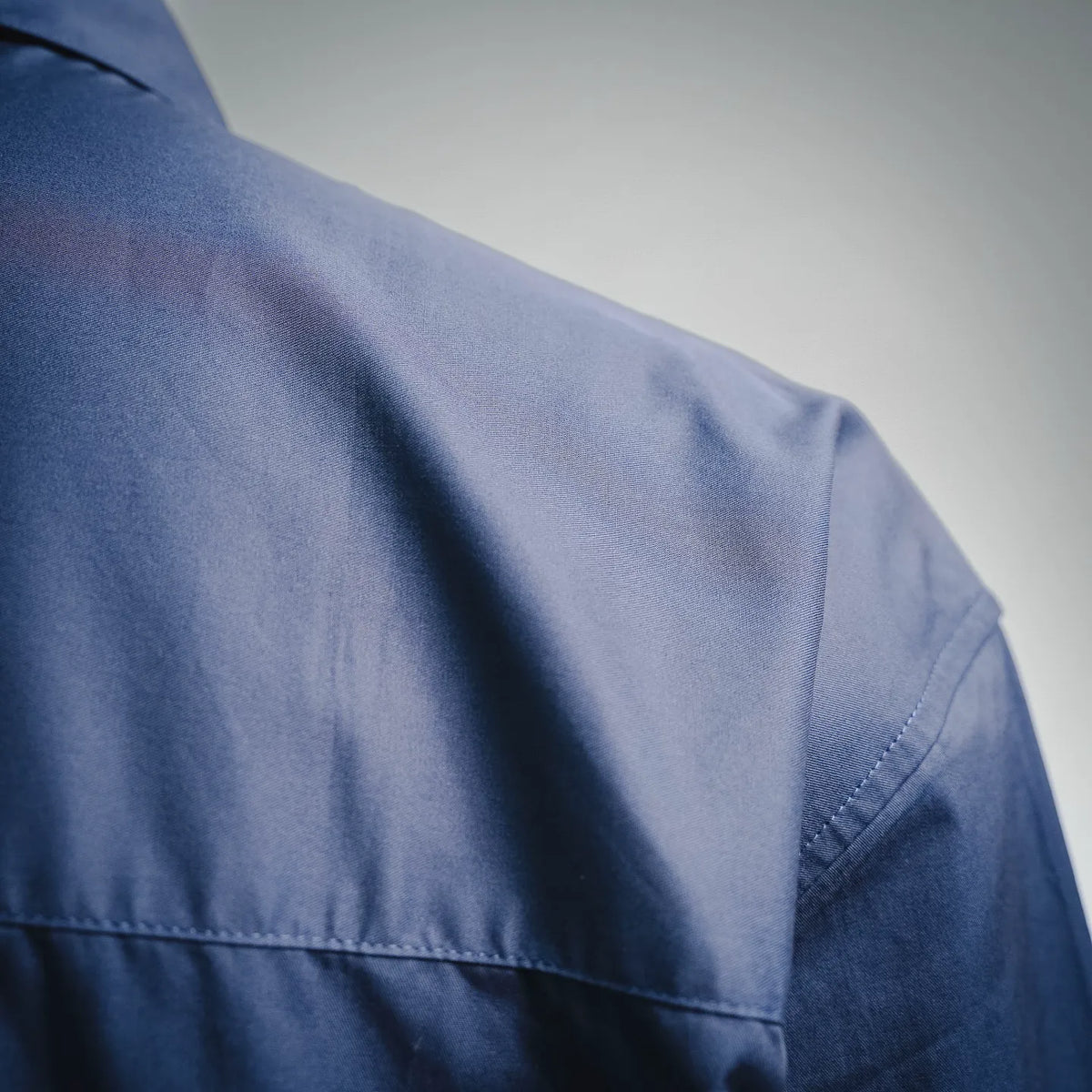 Blue long-sleeve shirt shoulder panel with topstitching detail