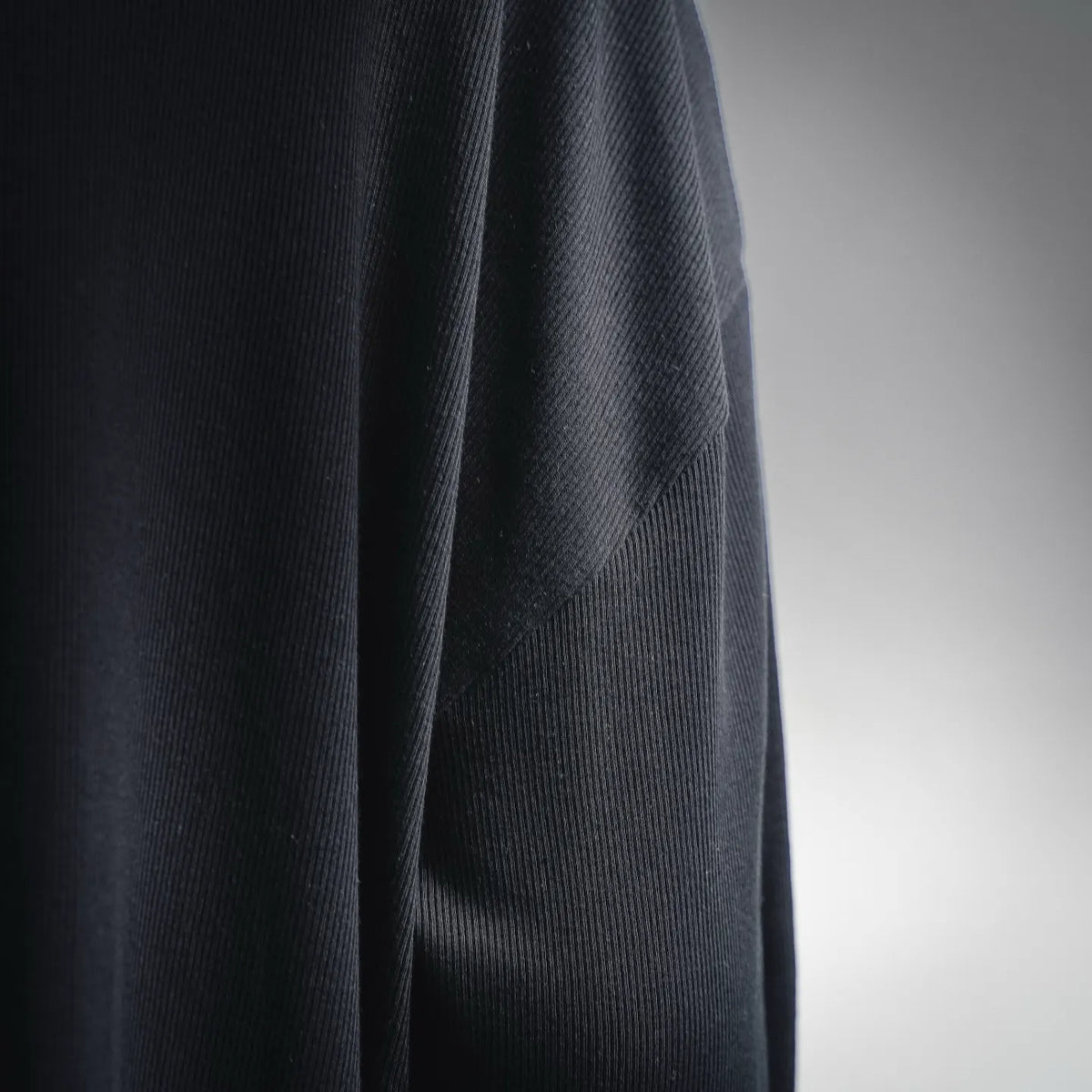 Dark knit fabric close-up on a LOEWE crewneck sweater