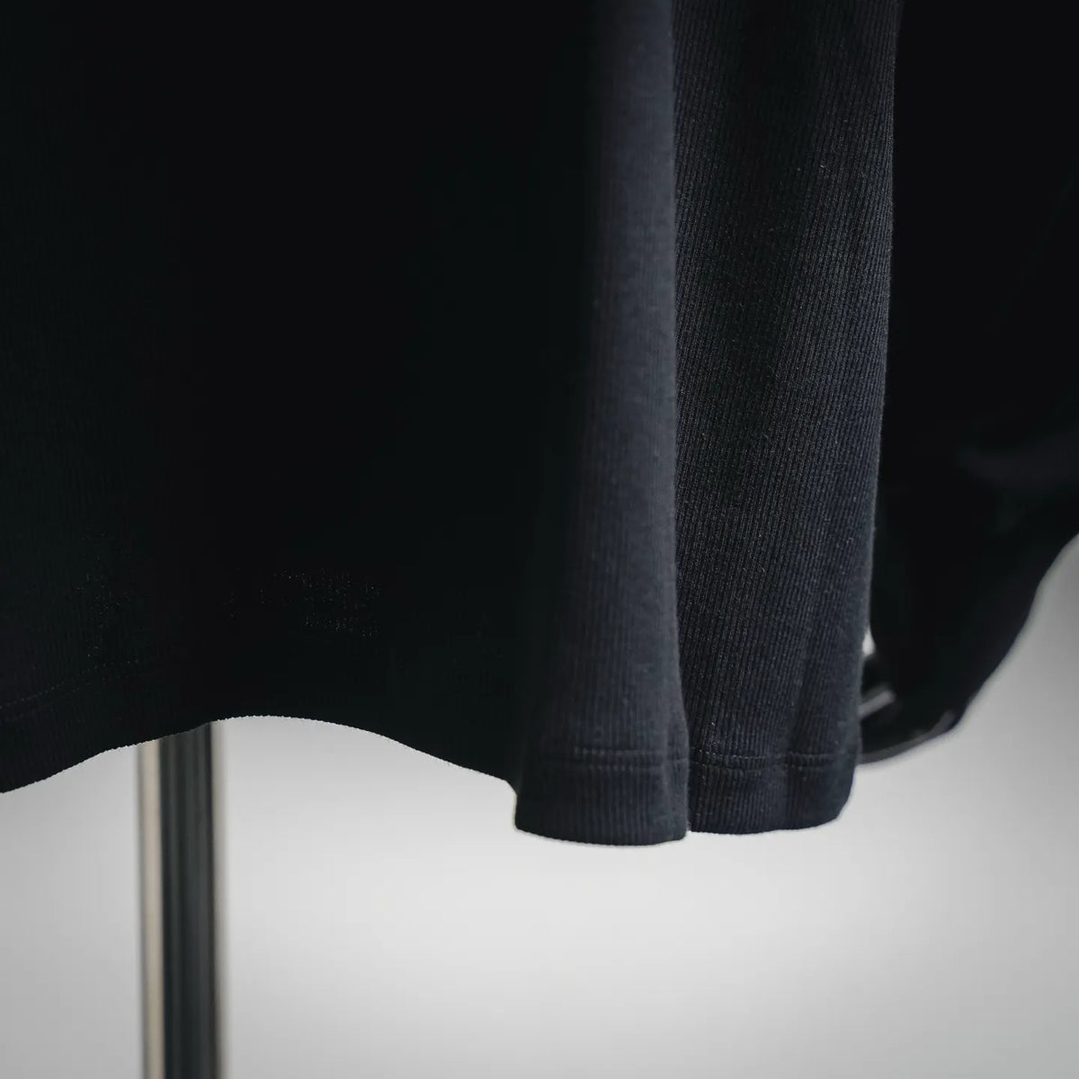 Dark sweater hem close-up with ribbed cuff edge