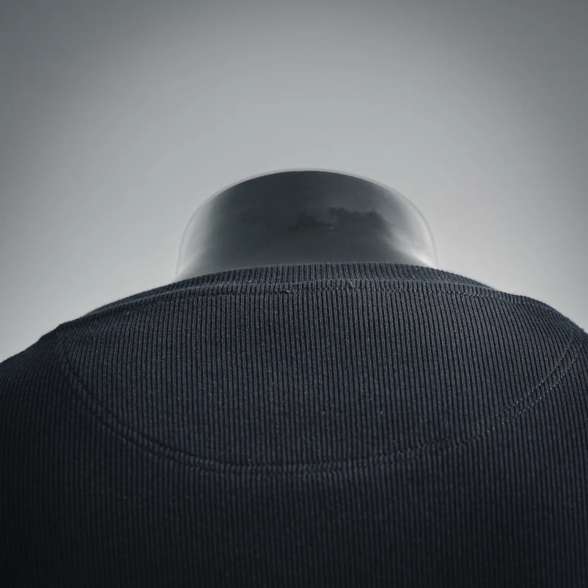Dark ribbed crewneck sweater collar detail on mannequin