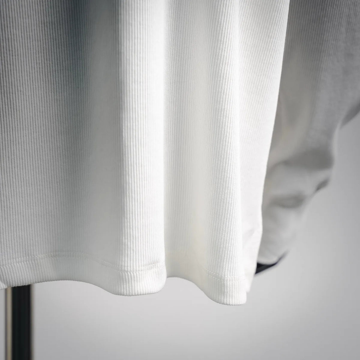 White crewneck sweatshirt hem with ribbed knit and side seam detail
