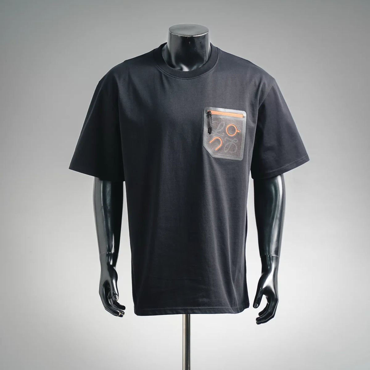 Black short-sleeve T-shirt with patch pocket featuring orange graphic and zipper.