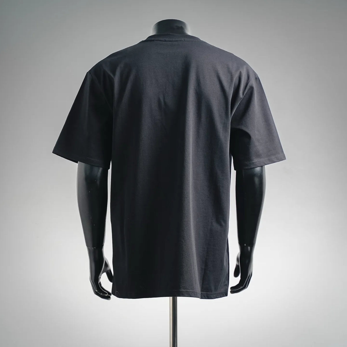 Black short-sleeve T-shirt with plain back and relaxed fit on mannequin.