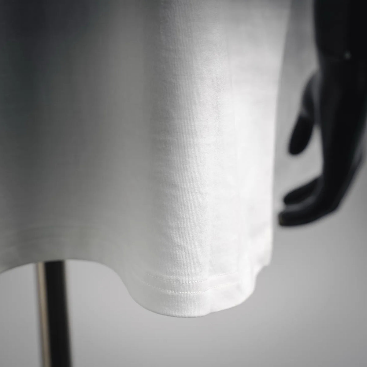 White T-shirt hem with visible stitching