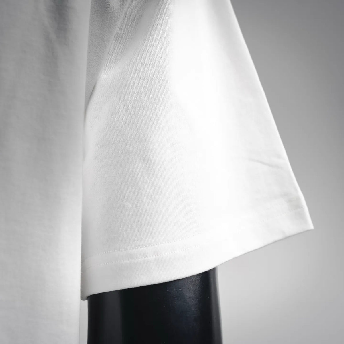 White T-shirt sleeve hem with smooth knit texture