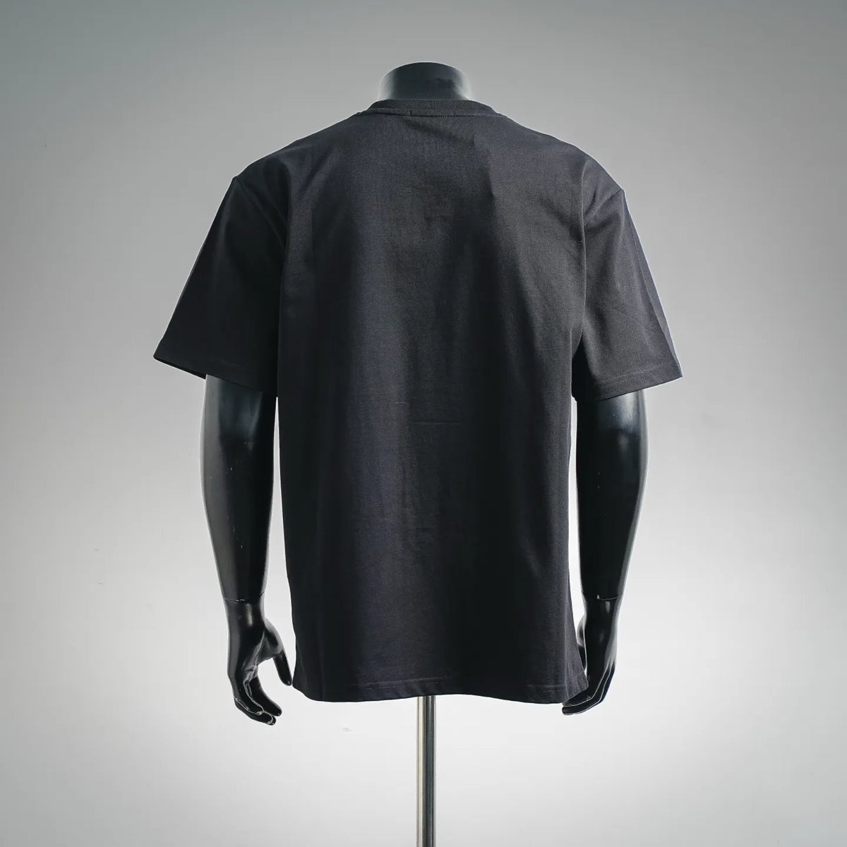 Black short-sleeve T-shirt on a mannequin, back view.