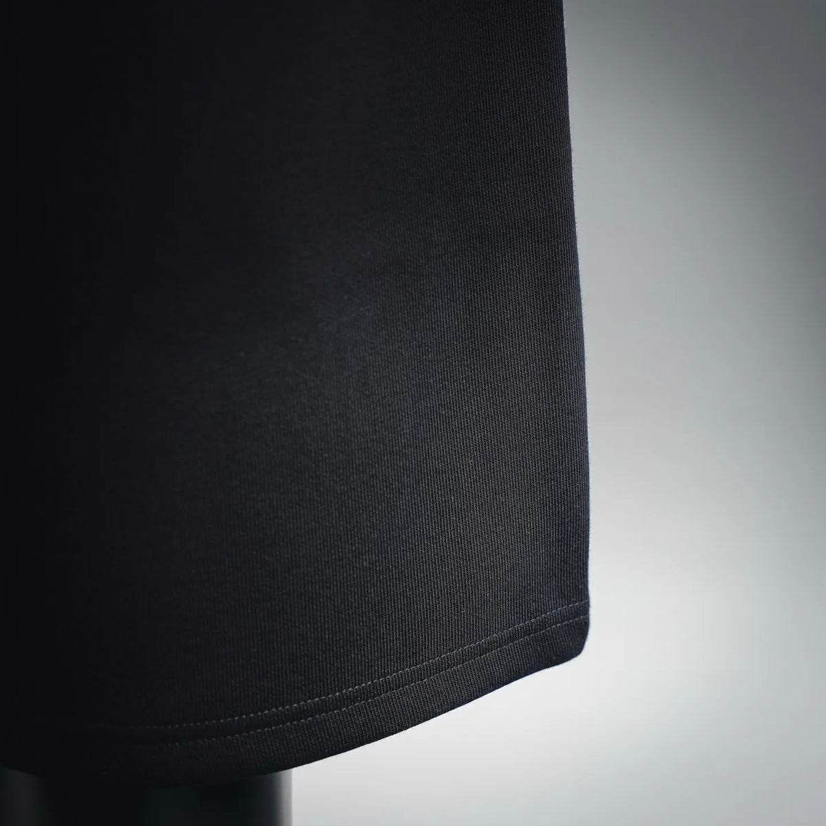 Black fabric shorts hem with clean stitched edge