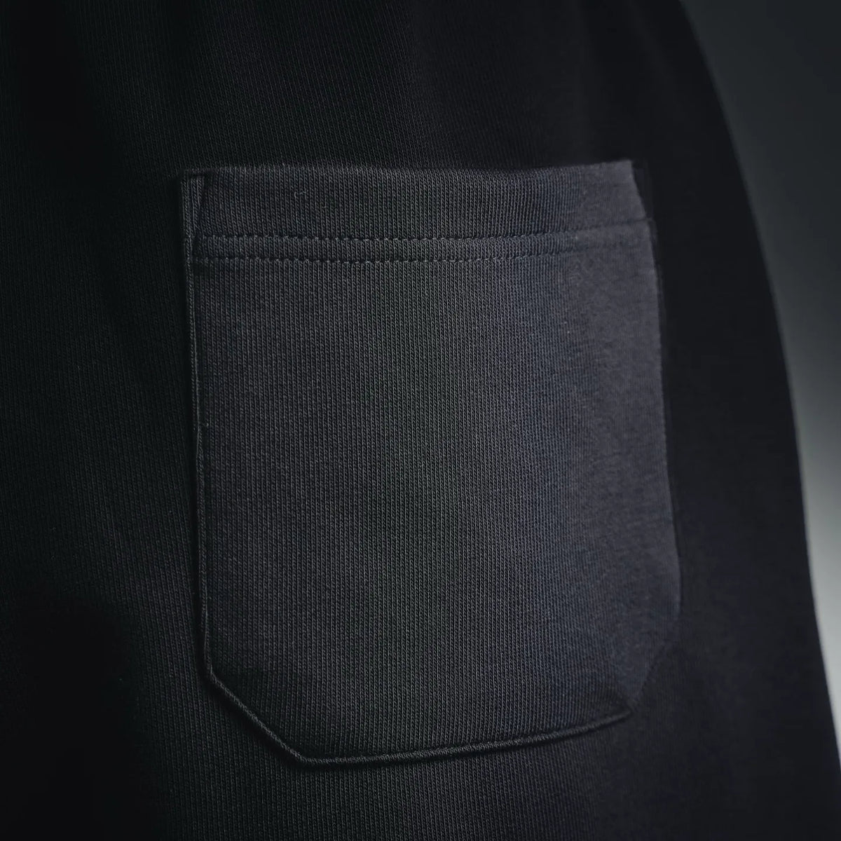 Black shorts side pocket with curved bartack stitching