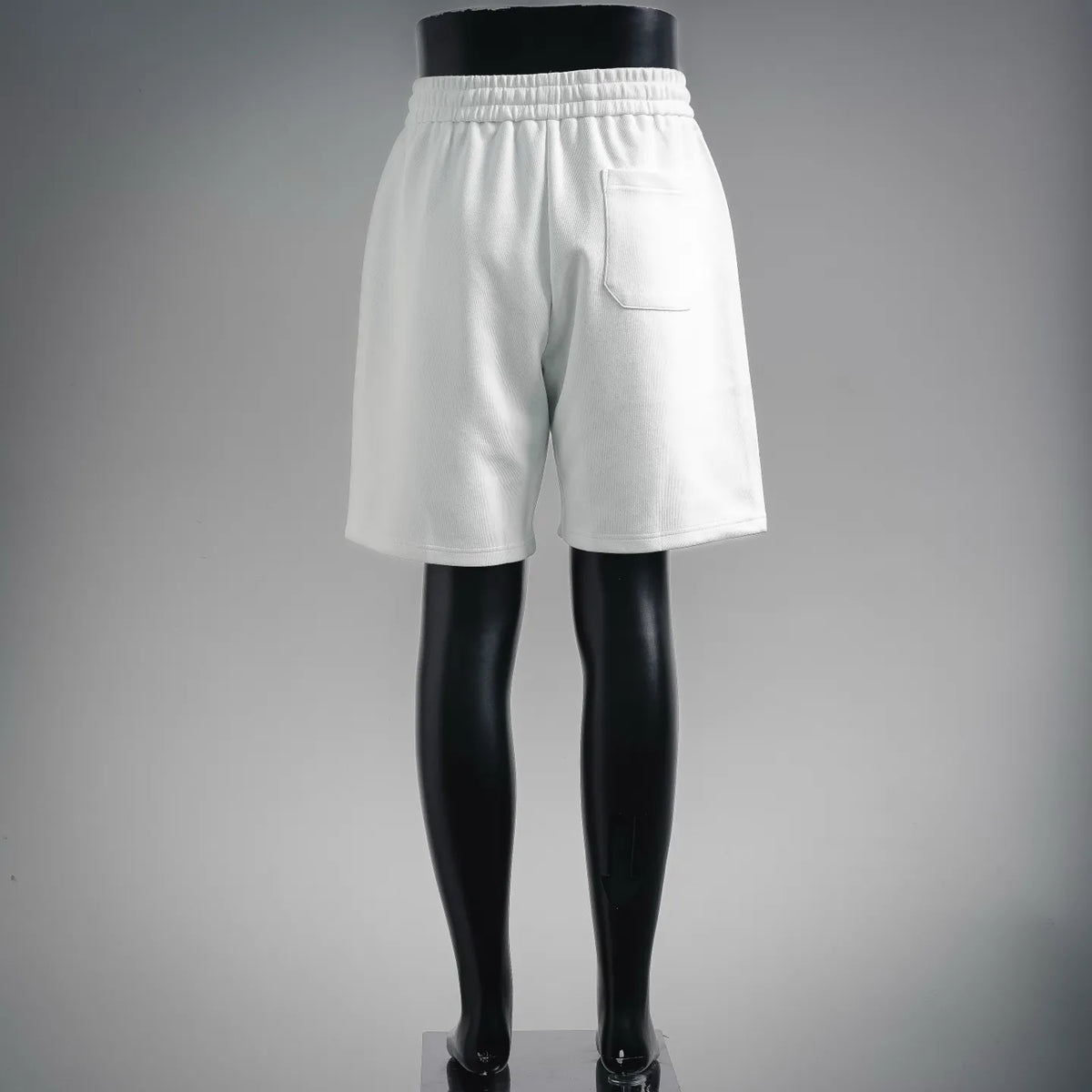 LOEWE white shorts with elastic waistband and stitched pocket detail on front