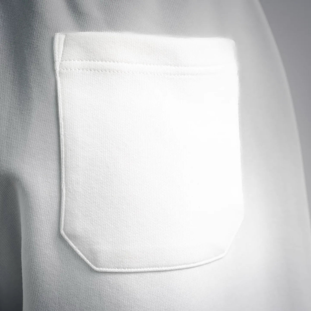 White shorts with front welt pocket, visible stitching and smooth fabric