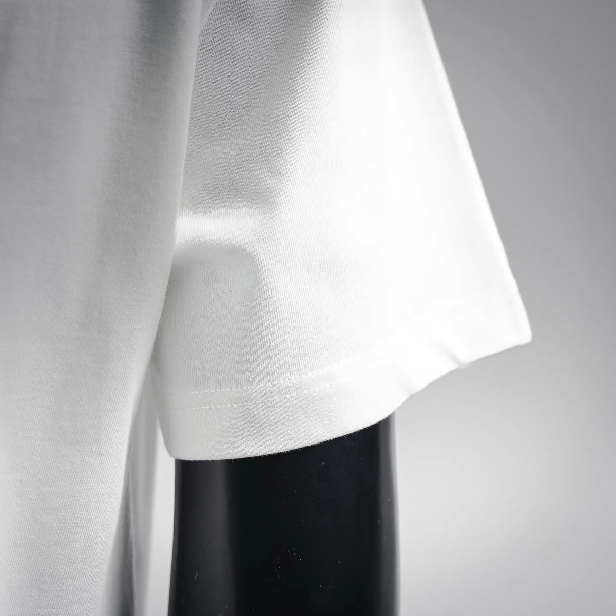 White T-shirt fabric and curved hem with visible stitching