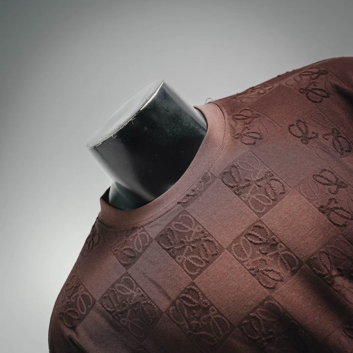 Taupe-brown short-sleeve T-shirt with repeating logo jacquard across the chest