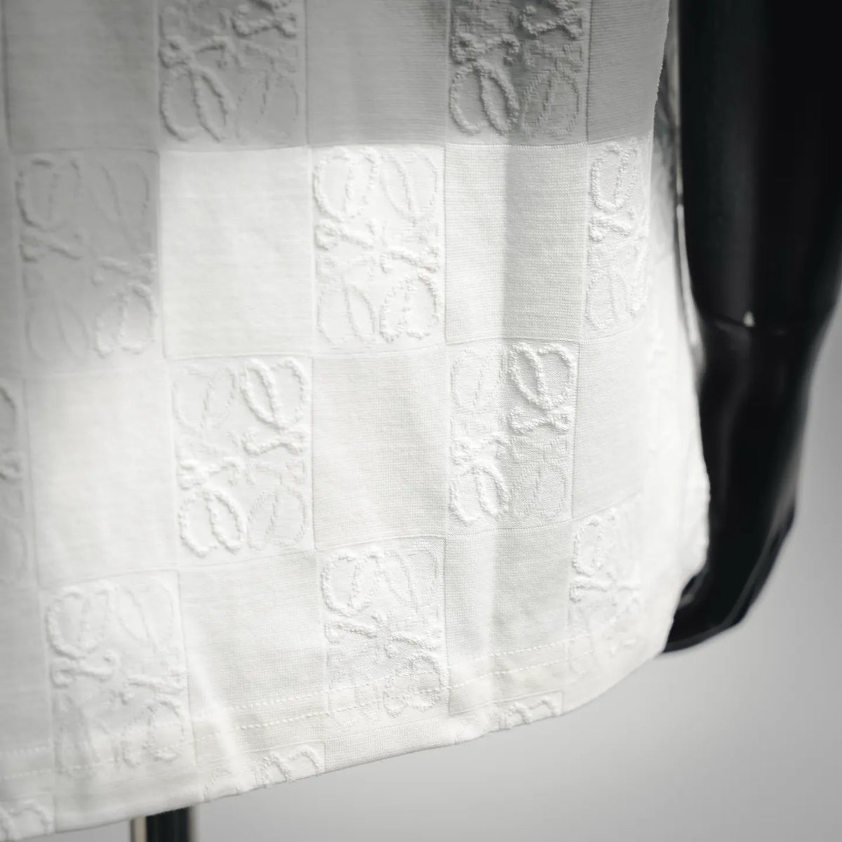 White textured shirt front with raised pattern blocks and stitched seams