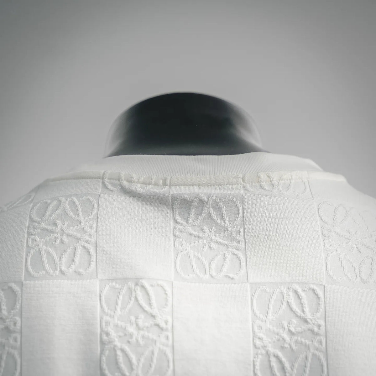 White raised pattern shirt at the collar and upper back area