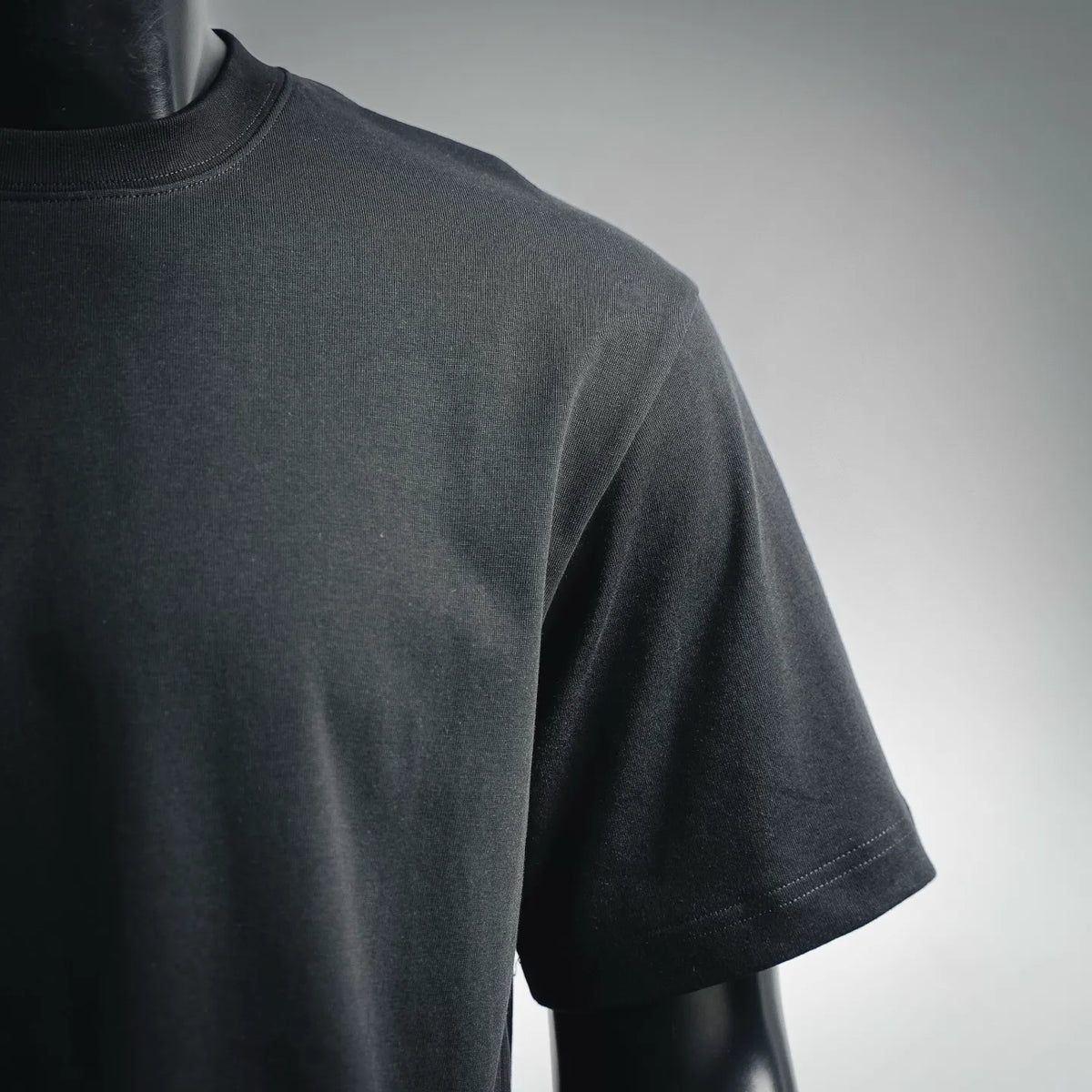 LOEWE short-sleeve T-shirt neckline and shoulder close-up, smooth dark knit