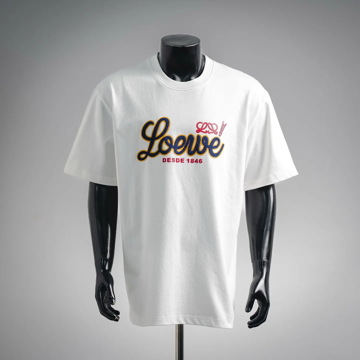 White LOEWE graphic T-shirt on a mannequin, crew neck, short sleeves.