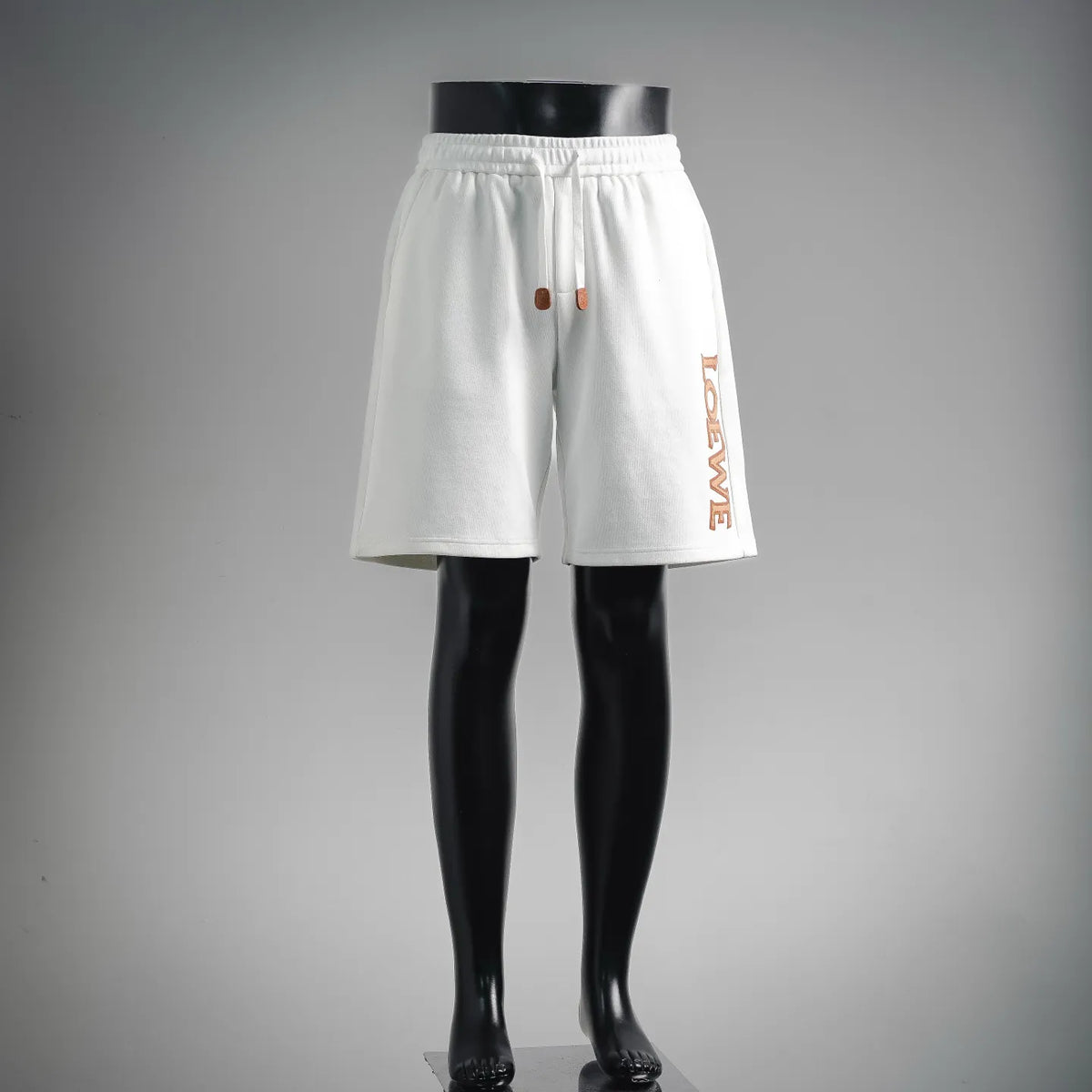 White LOEWE shorts with elastic waistband and orange graphic drawcord ends