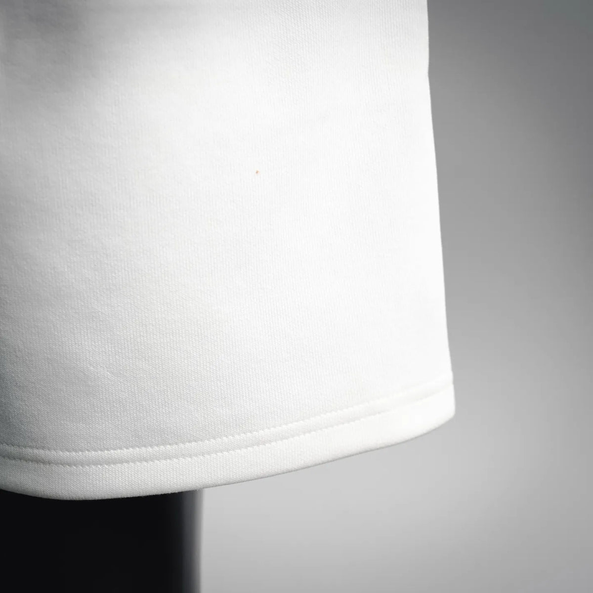 White shorts hem with visible stitched cuff