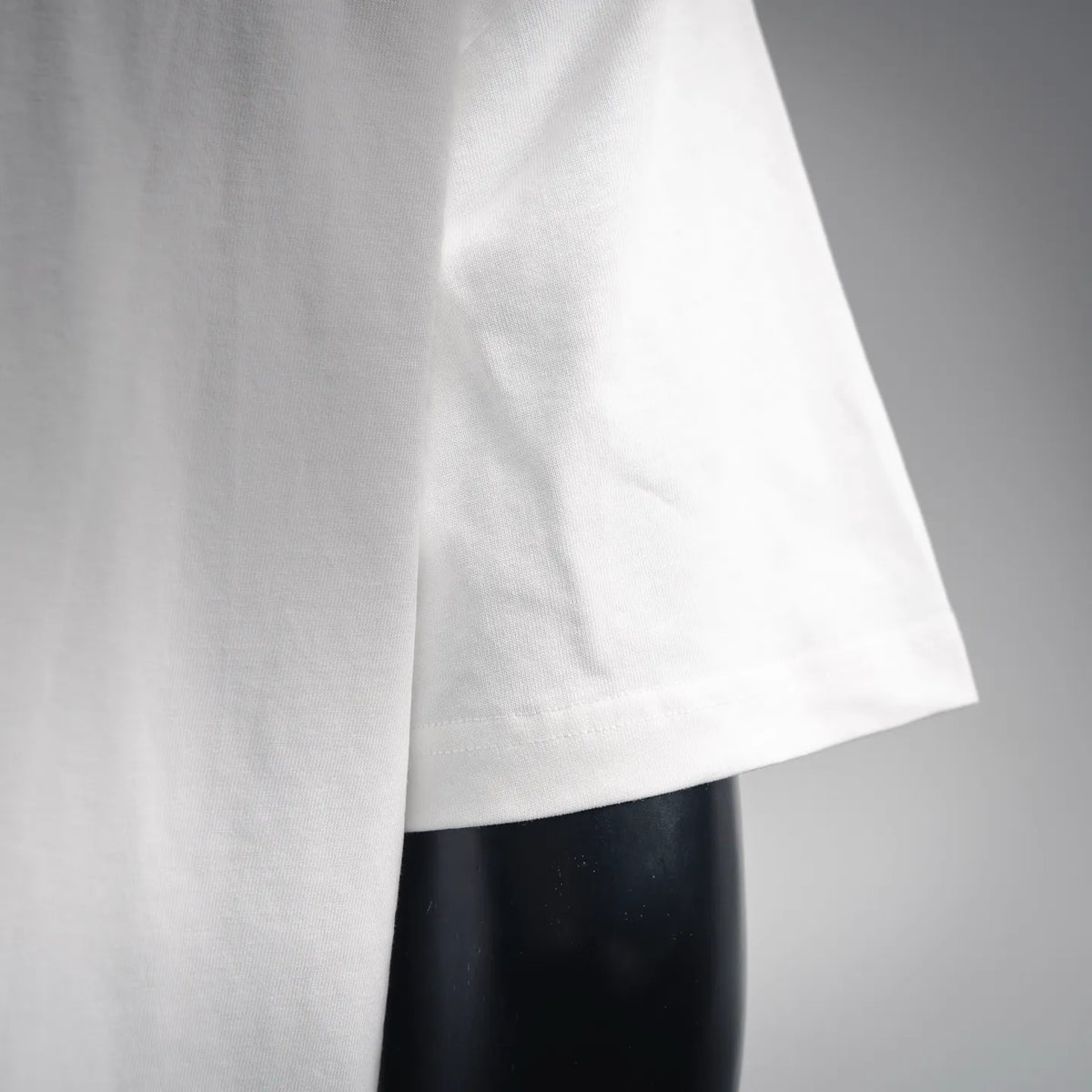White LOEWE T-shirt sleeve hem with visible seam and lightweight fabric