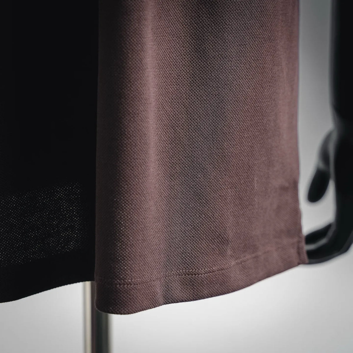 LOEWE dark plum polo shirt fabric close-up with textured knit surface
