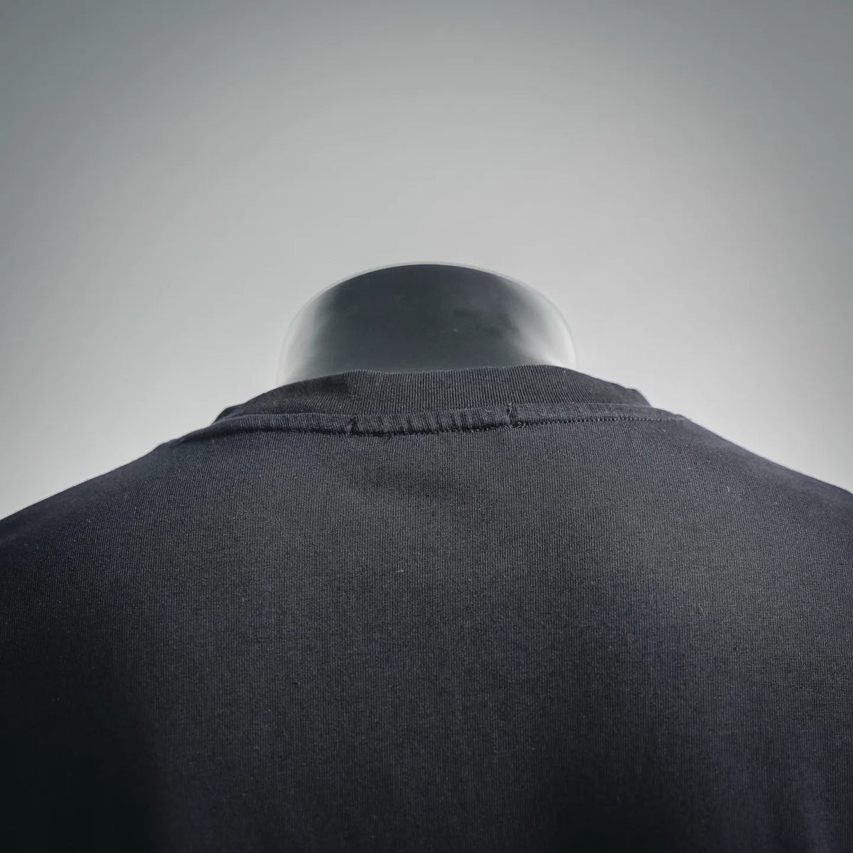 LOEWE dark T-shirt with close-up of crew neck and back yoke.