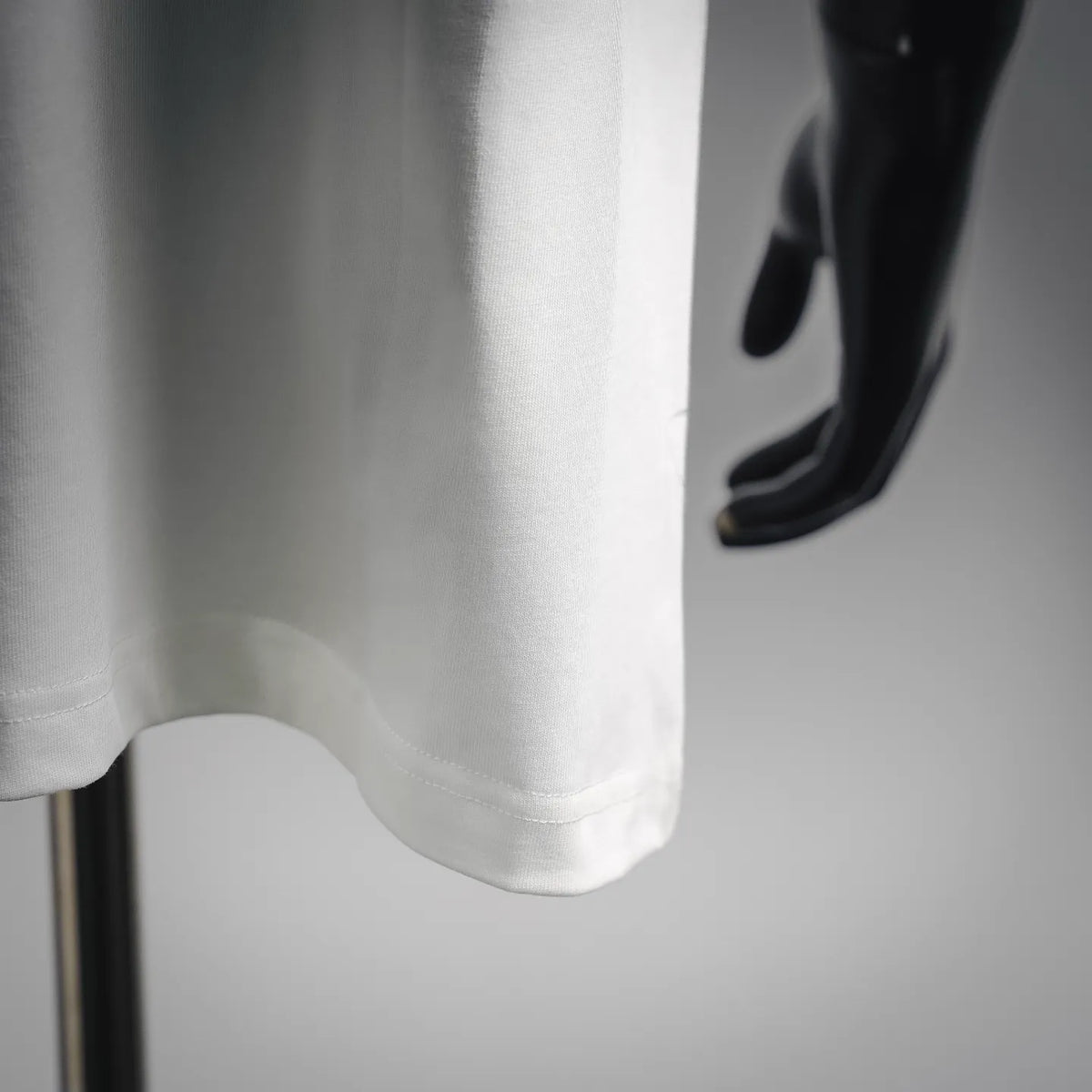 White T-shirt sleeve and curved hem detail