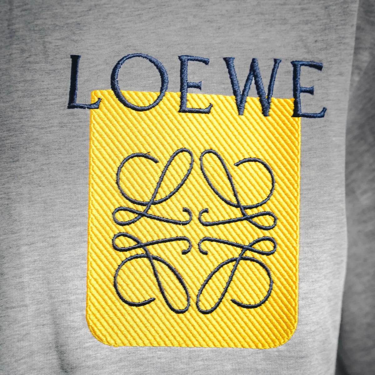 Grey T-shirt with yellow square embroidered LOEWE logo and blue lettering