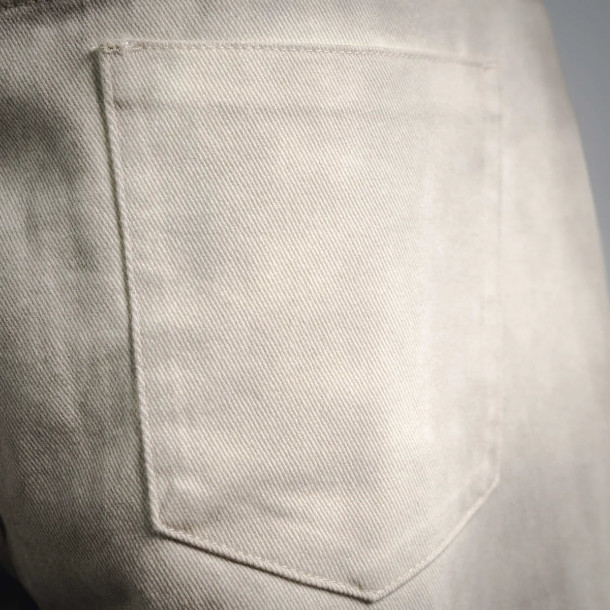 Beige pants back patch pocket with neat topstitching
