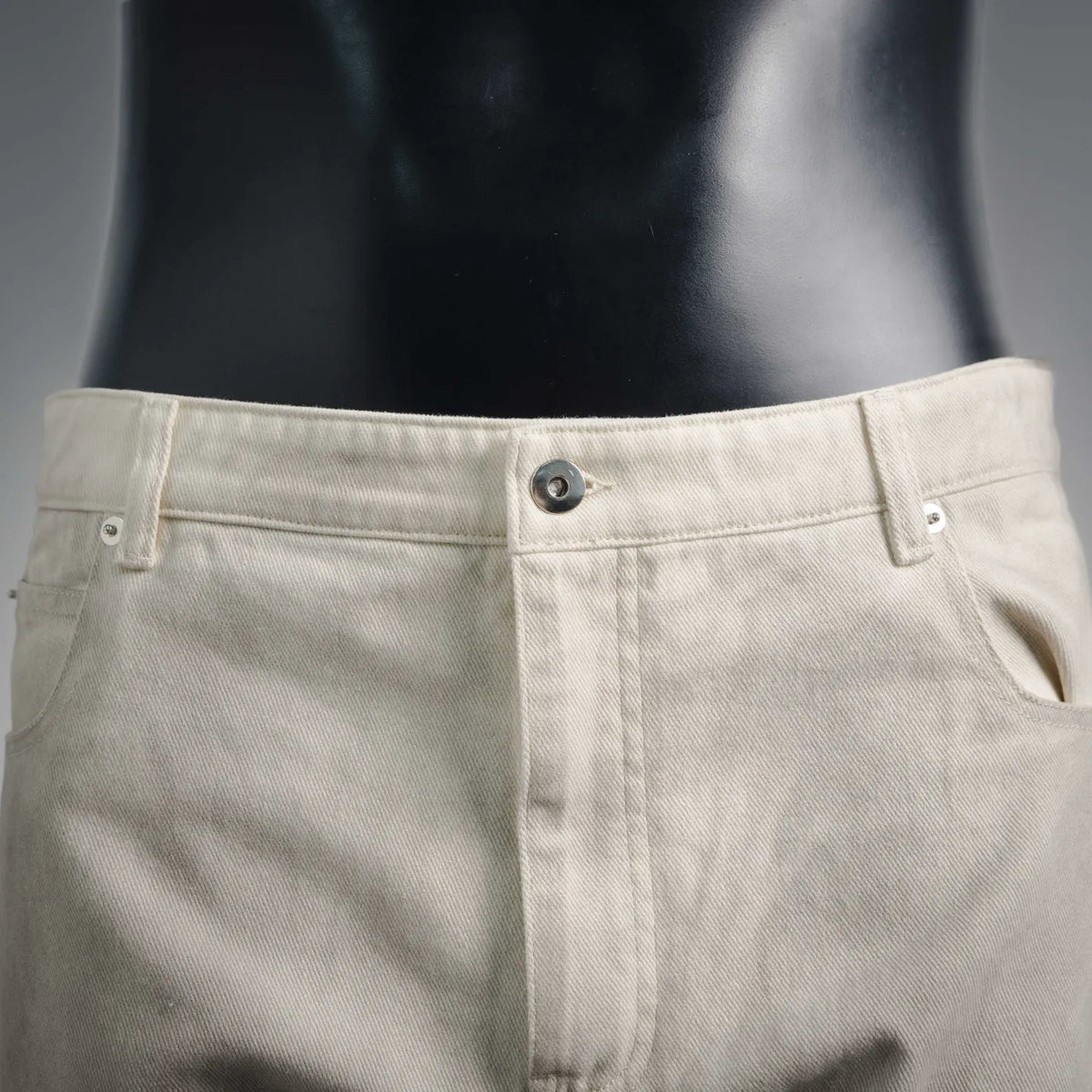 Beige pants waistband with button closure and belt loops