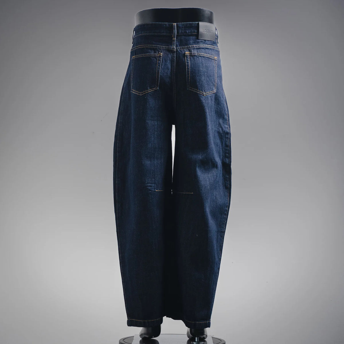 Dark blue denim pants with belt loops and front pockets