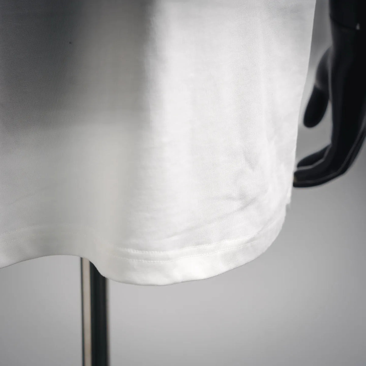 LOEWE white short-sleeve T-shirt fabric close-up, drape and hem