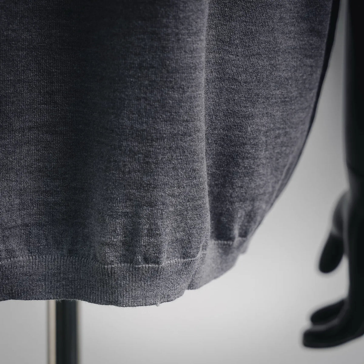 Gray knit fabric close-up with ribbed hem detail