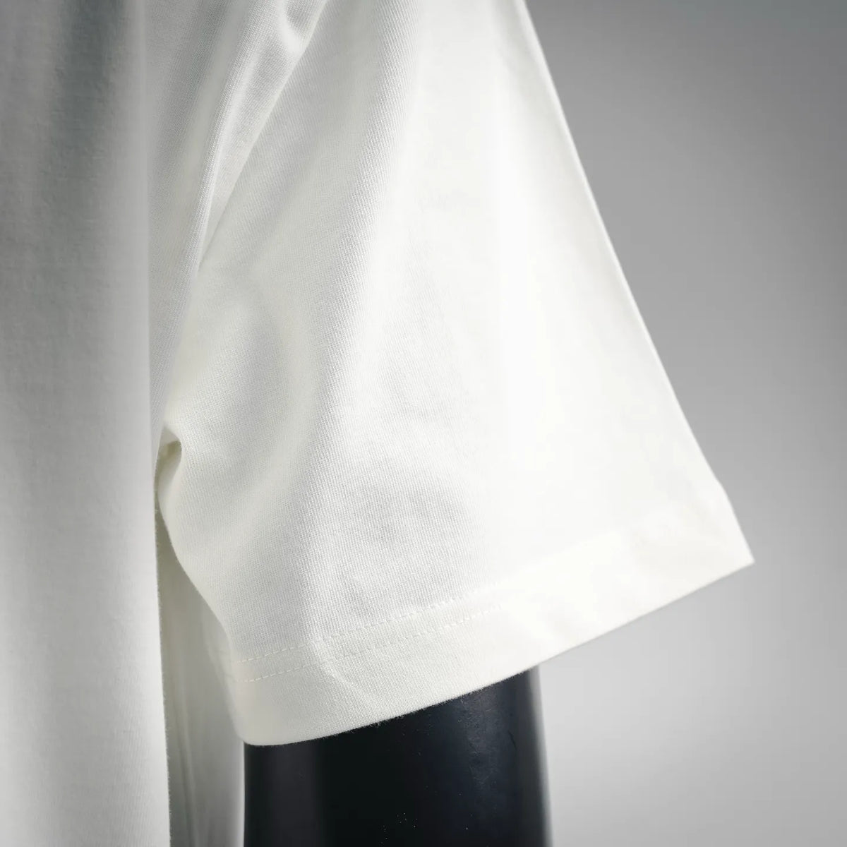White short-sleeve T-shirt side view with curved lower hem