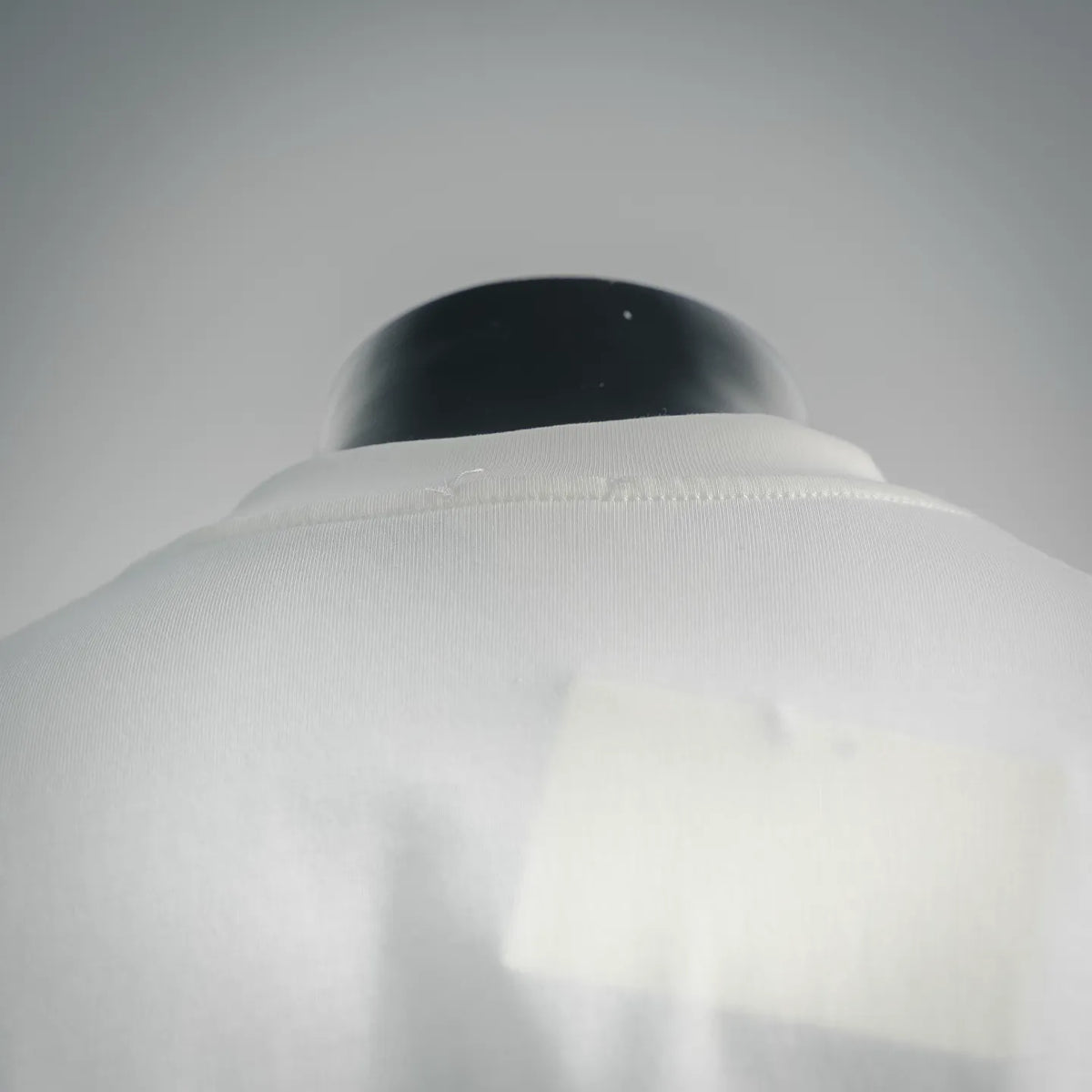 White T-shirt close-up of the back collar and shoulder seam