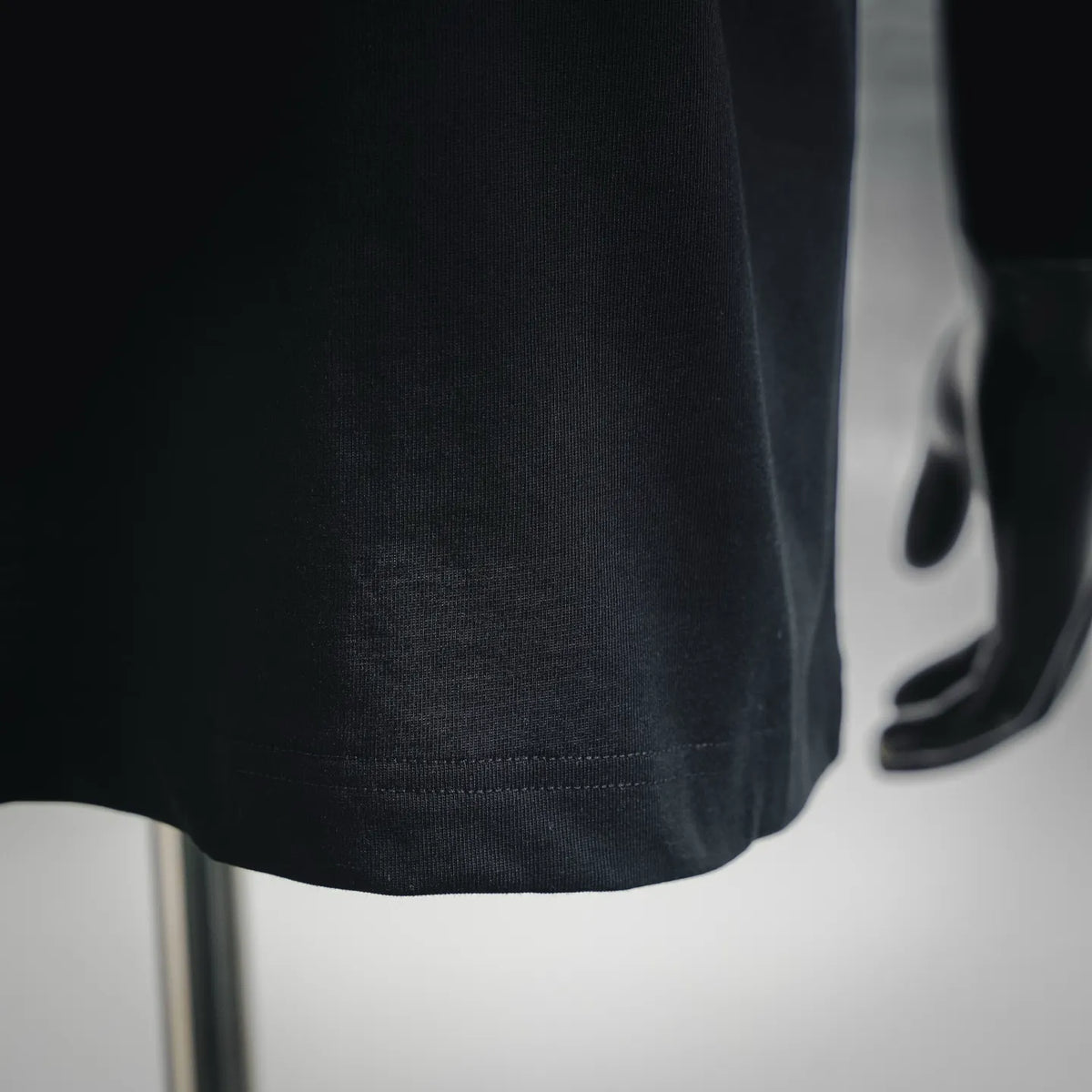 Black T-shirt hem with stitched edge detail